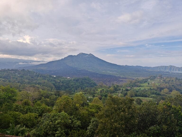 The serene Lake Batur surrounded by green hills in Bangli.