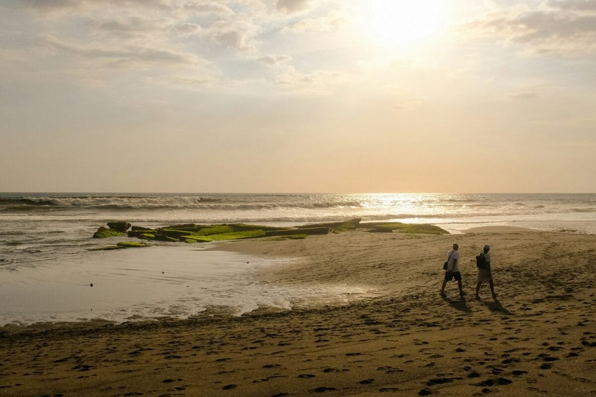 Surfer at sunset on Pererenan Beach in Bali.