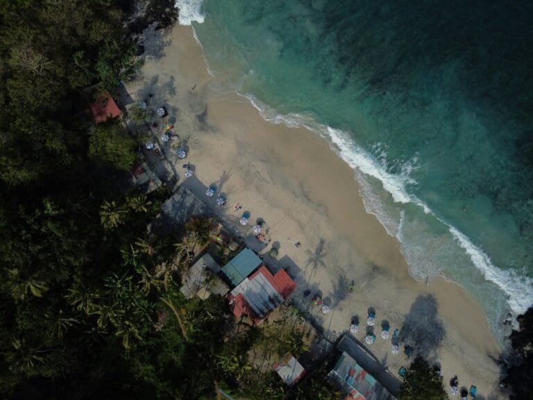 Padangbai beach with turquoise waters and boats.